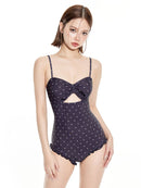 Women's One-Piece Swimsuit with Modest Fit and Support in polka dot design, showcasing stylish cutouts and ruffles.