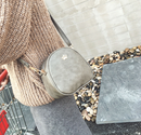 Crown Mini Shoulder Crossbody Bag styled with a cozy sweater, showcasing its chic design and high-quality PU material.
