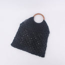 Handwoven beach tote bag in black with wooden handle, perfect for stylish everyday use.
