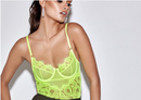 Floral lace bodysuit lingerie in neon yellow on model, showcasing intricate floral design and stylish silhouette.