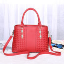 Red versatile crossbody handbag with woven design, suitable for handheld, shoulder, or crossbody use.
