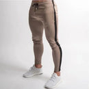 Slim fit casual pants for men in beige with black splice design and elastic waist, ideal for casual autumn and winter wear.