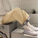 High-Waist Denim Cargo Pants with Nine Points worn in a stylish casual setting with white sneakers.
