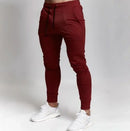 Men's slim fit casual pants for men in burgundy with elastic waist and lace-up style.