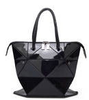 Women’s versatile handbag in glossy black with geometric design and dual handles for stylish versatility.