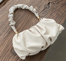 Elegant Cloud Bag showcasing a stylish design with a unique textured strap, perfect for everyday fashion.