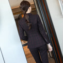 Plaid Formal Suit for Women's Office Attire showcasing a back view of a stylish suit in a modern office setting.