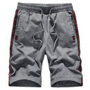 Trendy Brand loose casual sport pants in gray with black and red side stripes and drawstring for comfort.