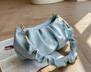 Versatile crossbody shoulder bag in light blue fabric with ruffled design, perfect for stylish everyday use.