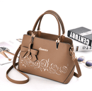 Women's Handbag, Shoulder Bag, Crossbody Bag featuring a stylish design with bows and floral accents.