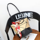 Stylish women's versatile handbag in geometric design with scarf detail, perfect for day and night use.