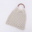 handwoven beach tote bag made from cotton rope with wooden handle, perfect for beach outings and daily use.