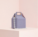 Stylish checkered crossbody shoulder bag with a chain strap on a pastel background.