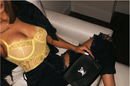 Floral lace bodysuit lingerie in yellow worn with ripped jeans and luxury handbag.