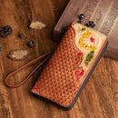 Hand-painted leather clutch purse featuring intricate floral designs and braided texture on a wooden background.