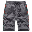 Trendy Brand loose casual sport pants in grey with colorful side stripes for comfortable athletic wear.