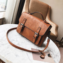 tassel handbag for modern women in brown leather, stylish commuter bag on a marble table