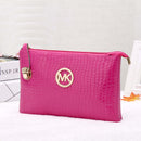 Crossbody, Shoulder Bag, Clutch Bag in vibrant pink with crocodile texture and gold logo.
