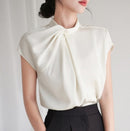 Elegant women's stand collar shirt with pleated details, perfect for a polished workwear look.