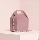 Checkered crossbody shoulder bag in light pink, featuring a chain strap and unique boxy design on display.