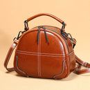 Stylish messenger bag in brown PU leather with a rounded design and adjustable shoulder strap.