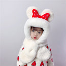 Cute child wearing thick children's scarves and hats with a plush design, featuring bear ears and a red polka dot bow.