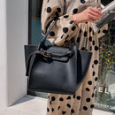 Versatile shoulder crossbody tote bag in black with chic design, suitable for casual and work outings.