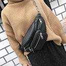 Stylish waist bag worn over a brown sweater, showcasing a versatile crossbody phone bag design with zippers.