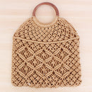 Handwoven beach tote bag featuring intricate design and wooden handle, perfect for stylish outings.