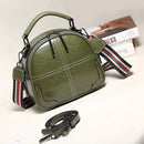 Stylish messenger bag in green PU leather with a modern design and striped shoulder strap.