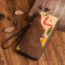 Hand-painted leather clutch purse showcasing intricate floral design and woven texture.