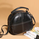 Stylish messenger bag made of black PU leather with a rounded design and stylish stitching detail.