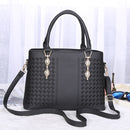 versatile crossbody handbag in black, featuring stylish braided design and adjustable shoulder strap.