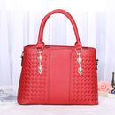 versatile crossbody handbag in red with braided design and elegant golden accents.