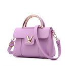 Versatile shoulder crossbody tote bag in elegant lavender with gold accents and a top handle.