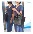Model showcasing a versatile shoulder crossbody tote bag in a stylish setting.