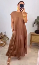 Women in a chic women's loose solid color dress, showcasing a relaxed fit and elegant pleated design in a warm brown hue.