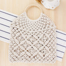 Handwoven beach tote bag made from cotton rope with unique macrame design and wooden handle.
