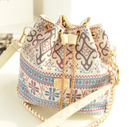 Ethnic style canvas bucket bag with intricate patterns and gold accents, perfect for everyday use.