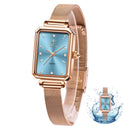 Luxury women’s square analog watch with blue dial, diamond indexes, and rose gold mesh strap, waterproof design by Taxau.