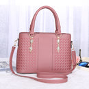 Versatile crossbody handbag in pink with braided design and detachable strap for multiple carrying styles.