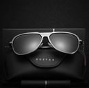 Polarized sunglasses for men with a sleek design and black case resting on a dark background.